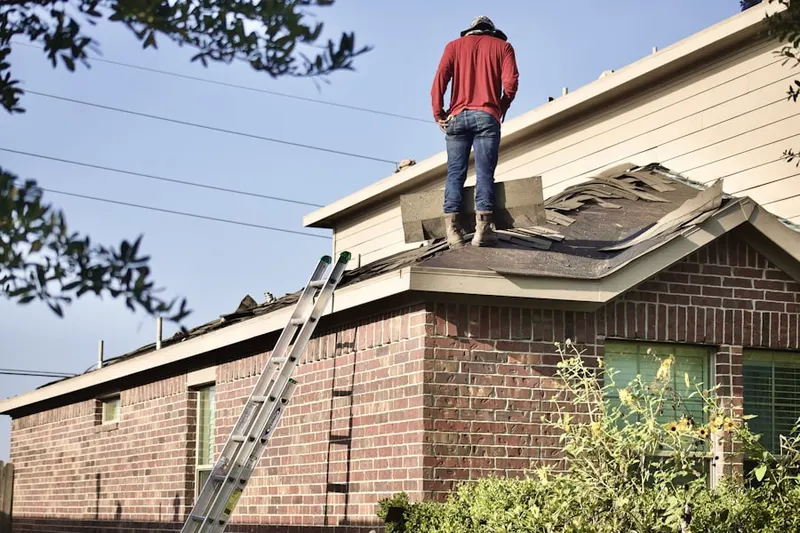 Professional roofer working on a residential roof in Oak Bluffs